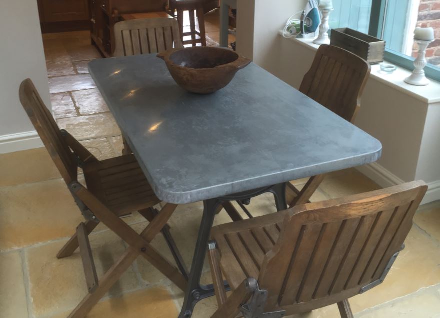 Bespoke zinc natural metal topped table made by hand at UKAA by our team of skilled joiners with a reclaimed antique cast iron painted base